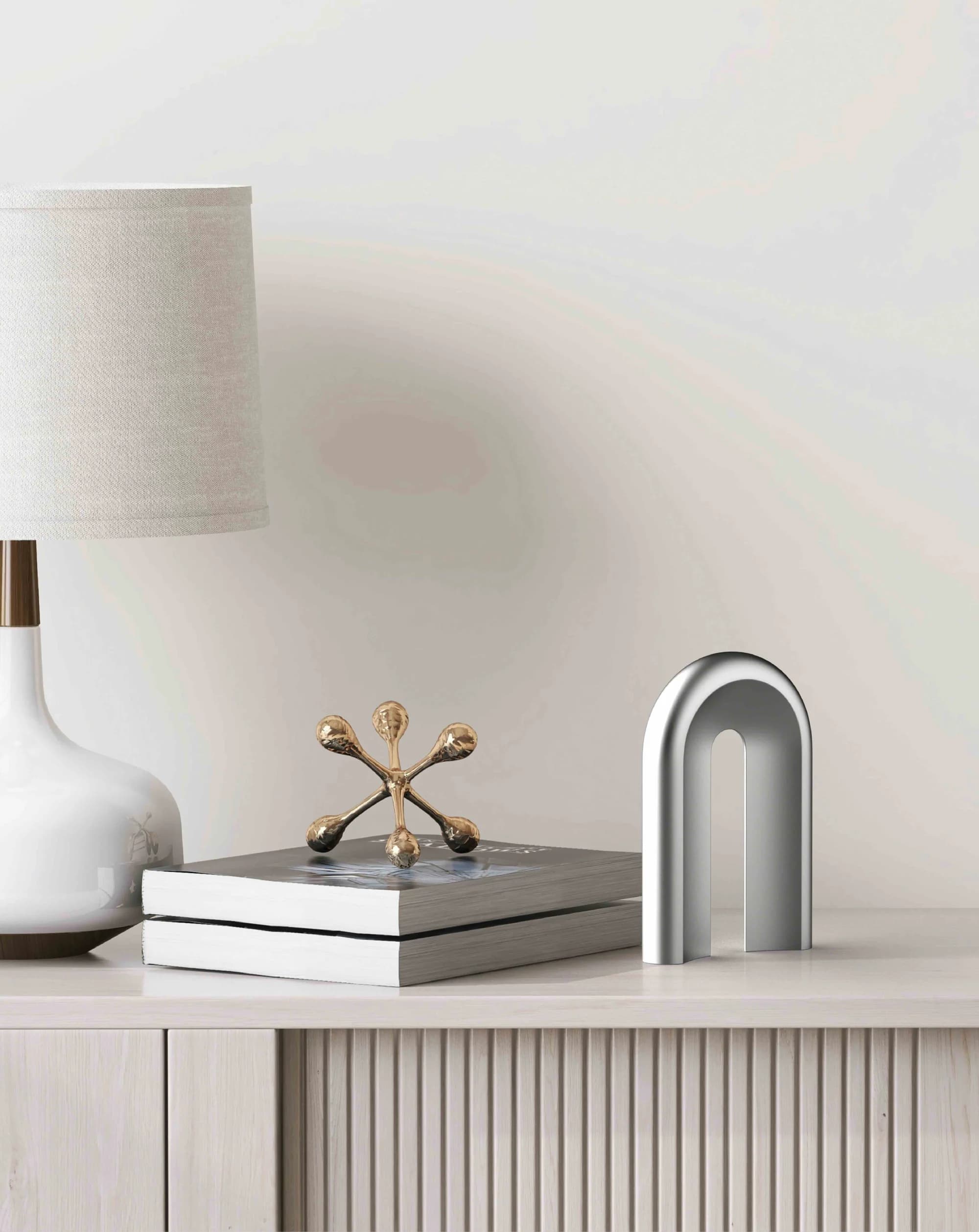 Berg standing beside books and a lamp